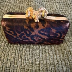 C. Wonder Brown and Black Animal Print Clutch with Gold Ram Accent